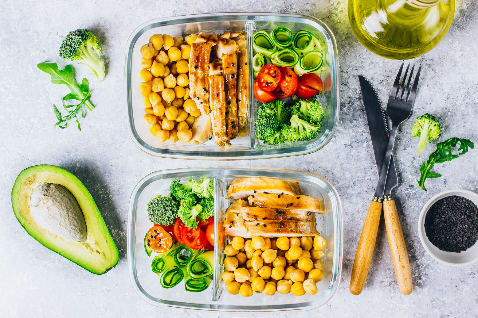 Healthy meal prep containers chicken and fresh vegetables.